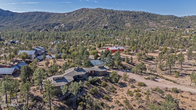 aerial view with a mountain view and a wooded view