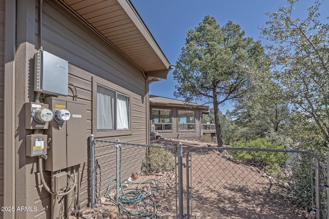 view of side of home featuring a gate and fence