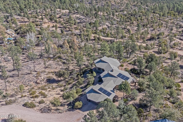 bird's eye view with a wooded view