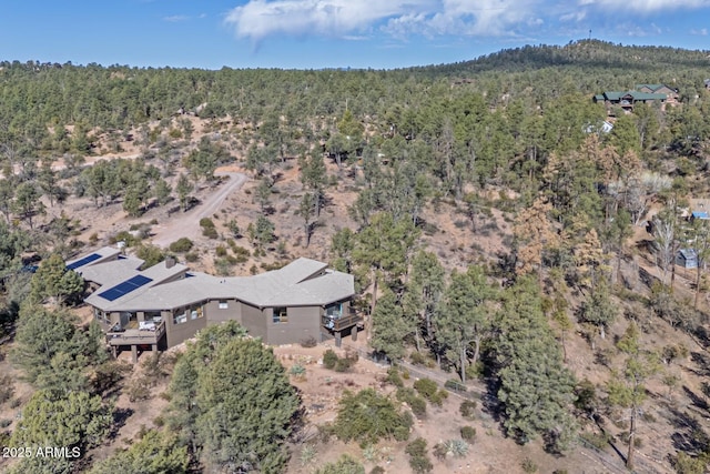 birds eye view of property with a wooded view