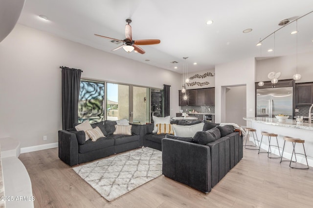 8725 E Menlo Cir, Mesa, AZ 85207 - living room with light wood-type flooring, recessed lighting, and a ceiling fan