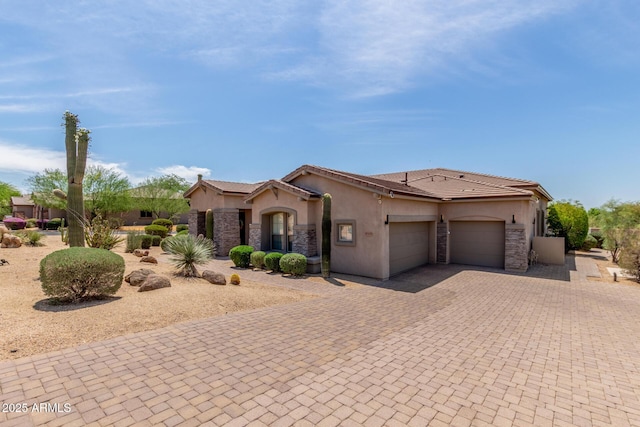 8725 E Menlo Cir, Mesa, AZ 85207 - mediterranean / spanish home with an attached garage, stucco siding, decorative driveway, a tile roof, and stone siding