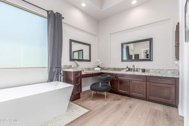 8725 E Menlo Cir, Mesa, AZ 85207 - full bathroom featuring a freestanding bath, double vanity, wood finished floors, and recessed lighting