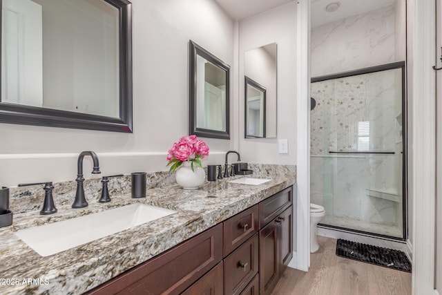 8725 E Menlo Cir, Mesa, AZ 85207 - bathroom with toilet, a marble finish shower, double vanity, and wood finished floors