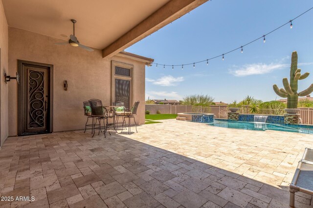8725 E Menlo Cir, Mesa, AZ 85207 - fenced backyard with a pool with connected hot tub, a patio, and a ceiling fan