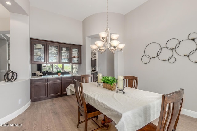 8725 E Menlo Cir, Mesa, AZ 85207 - dining area with a chandelier, light wood-style floors, and baseboards