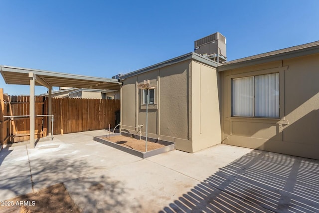 back of property with fence, a patio, and central AC unit