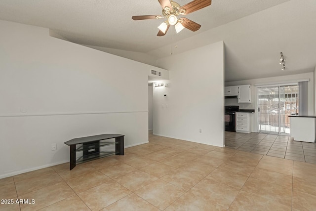 unfurnished living room with lofted ceiling, ceiling fan, a textured ceiling, light tile patterned flooring, and baseboards