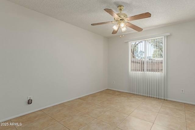 unfurnished room with ceiling fan, baseboards, a textured ceiling, and light tile patterned flooring