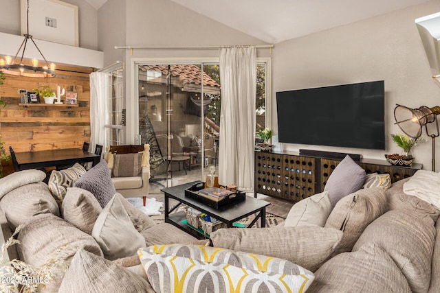 living room with a notable chandelier and lofted ceiling