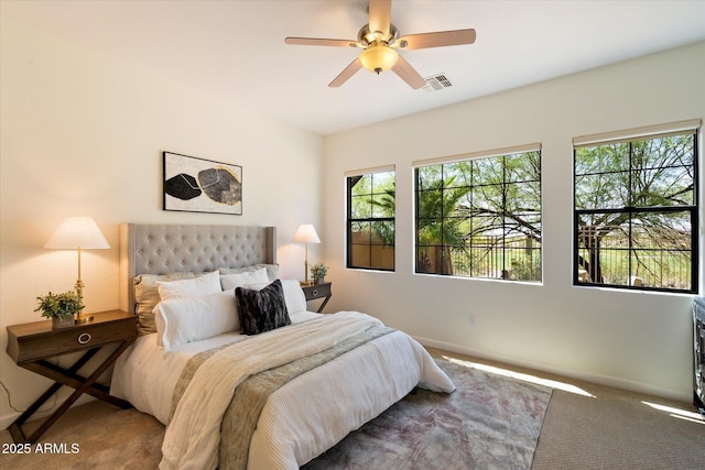 bedroom with baseboards, a ceiling fan, carpet flooring, and visible vents