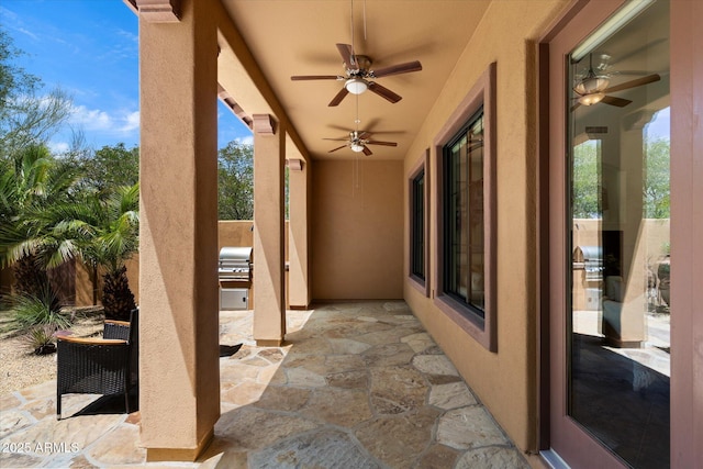 view of patio with an outdoor kitchen, ceiling fan, and grilling area