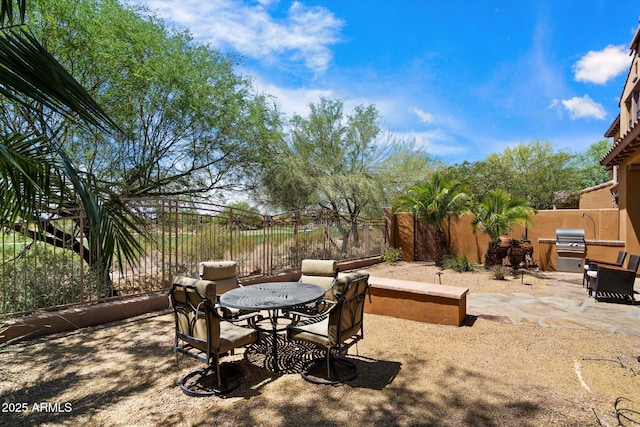 view of yard featuring a fenced backyard, a patio, and outdoor dining space