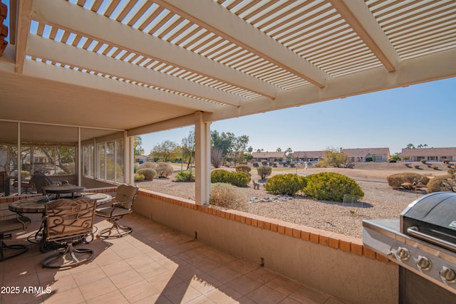 view of patio featuring area for grilling and a pergola