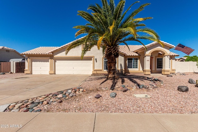 2356 N Glenview, Mesa, AZ 85213 - mediterranean / spanish house featuring stucco siding, a tiled roof, concrete driveway, and an attached garage