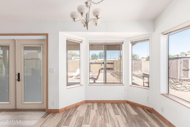 2356 N Glenview, Mesa, AZ 85213 - unfurnished dining area featuring baseboards, a notable chandelier, light wood-style floors, and french doors