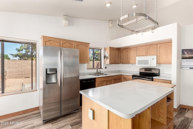2356 N Glenview, Mesa, AZ 85213 - kitchen with a sink, stainless steel appliances, light wood-type flooring, a kitchen island, and light countertops
