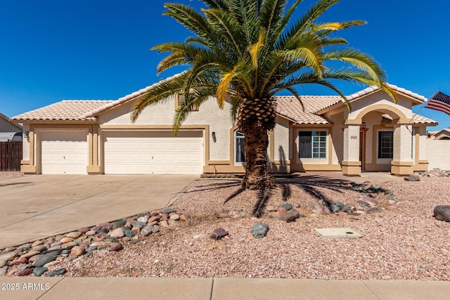2356 N Glenview, Mesa, AZ 85213 - mediterranean / spanish-style house with a garage, a tiled roof, concrete driveway, stucco siding, and fence