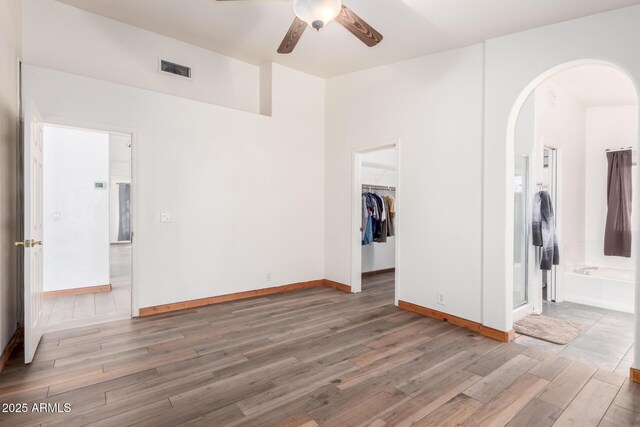 2356 N Glenview, Mesa, AZ 85213 - unfurnished room with ceiling fan, visible vents, baseboards, arched walkways, and wood finished floors