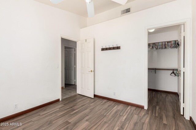 2356 N Glenview, Mesa, AZ 85213 - unfurnished bedroom featuring a closet, a walk in closet, visible vents, baseboards, and wood finished floors