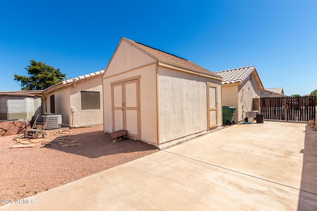 2356 N Glenview, Mesa, AZ 85213 - view of property exterior with a patio, an outdoor structure, a storage shed, central AC, and a tiled roof