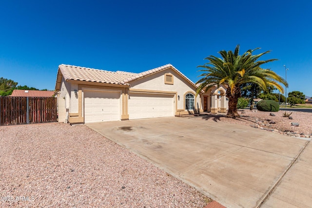 2356 N Glenview, Mesa, AZ 85213 - mediterranean / spanish house featuring stucco siding, fence, concrete driveway, and a garage