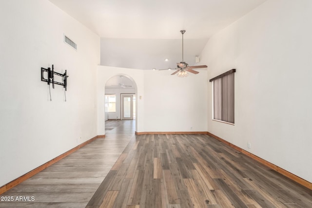 2356 N Glenview, Mesa, AZ 85213 - unfurnished living room featuring arched walkways, visible vents, ceiling fan, and wood finished floors