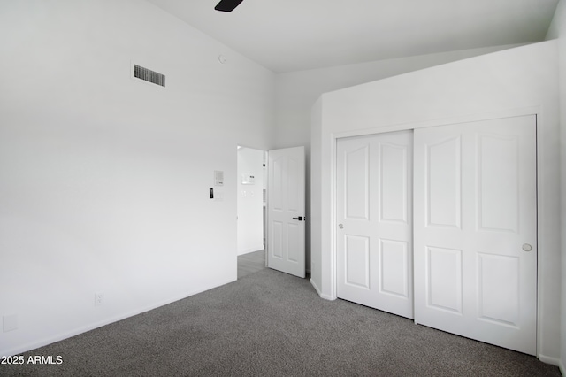 unfurnished bedroom with carpet flooring, ceiling fan, and a closet