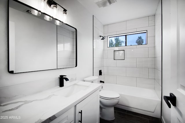 full bathroom featuring vanity, toilet, tiled shower / bath combo, and hardwood / wood-style floors