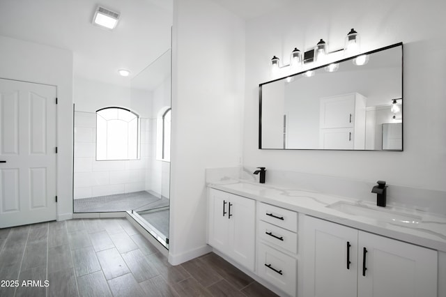 bathroom featuring vanity and a tile shower