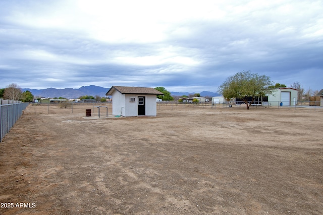 view of yard with a mountain view and a storage unit