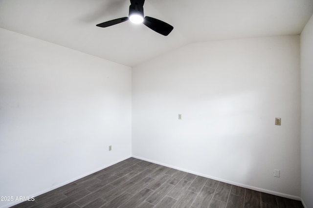 empty room featuring lofted ceiling, dark wood-type flooring, and ceiling fan