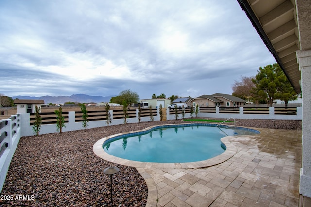 view of pool featuring a mountain view and a patio