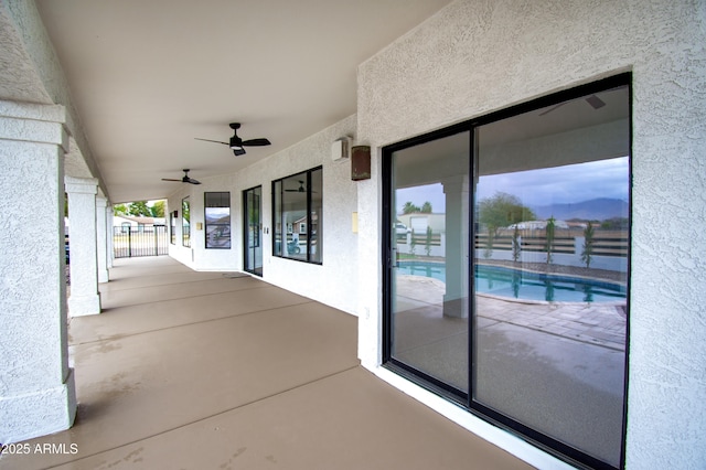 view of patio with a fenced in pool and ceiling fan