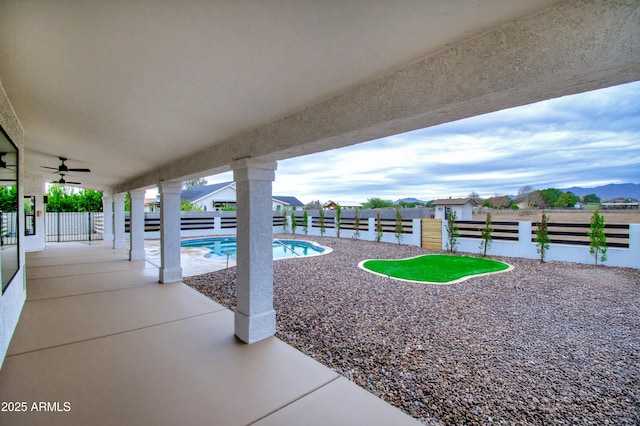 view of pool featuring ceiling fan and a patio area