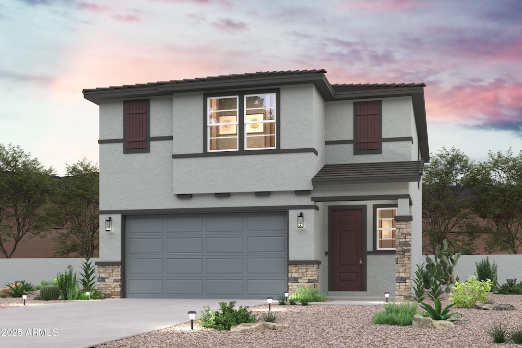 view of front of property with stucco siding, stone siding, a garage, and driveway