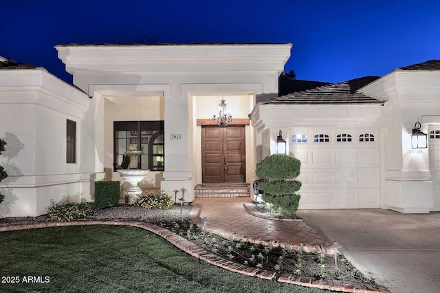 2041 W Hemlock Way, Chandler, AZ 85248 - view of exterior entry with a garage, concrete driveway, and stucco siding
