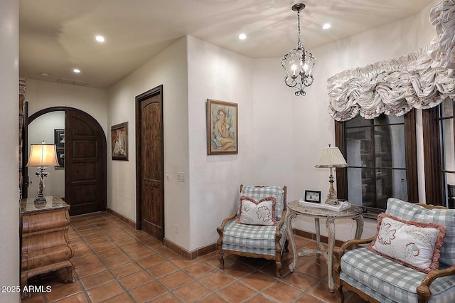 2041 W Hemlock Way, Chandler, AZ 85248 - sitting room with arched walkways, baseboards, recessed lighting, tile patterned floors, and a chandelier