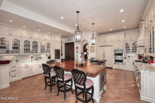 2041 W Hemlock Way, Chandler, AZ 85248 - kitchen with paneled built in refrigerator, double oven, tasteful backsplash, recessed lighting, and butcher block countertops