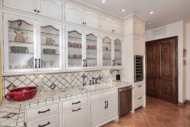 2041 W Hemlock Way, Chandler, AZ 85248 - kitchen featuring tile countertops, a sink, beverage cooler, stainless steel dishwasher, and tasteful backsplash