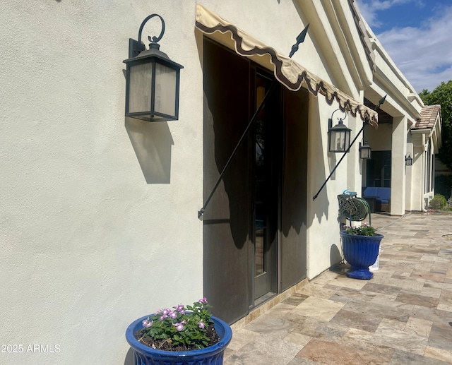 2041 W Hemlock Way, Chandler, AZ 85248 - view of exterior entry with a patio area and stucco siding