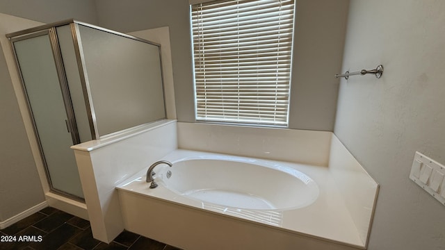 bathroom featuring separate shower and tub