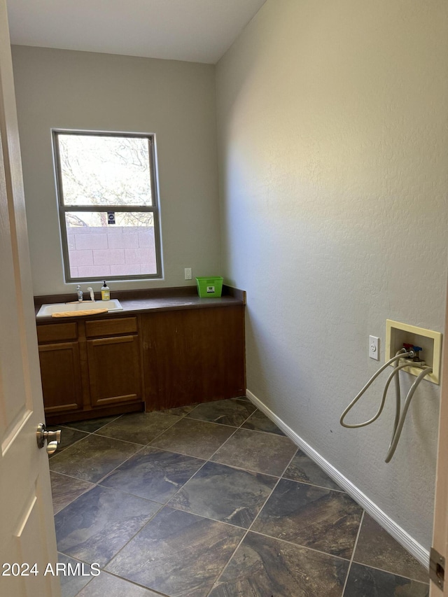 interior space featuring cabinets, hookup for a washing machine, and sink