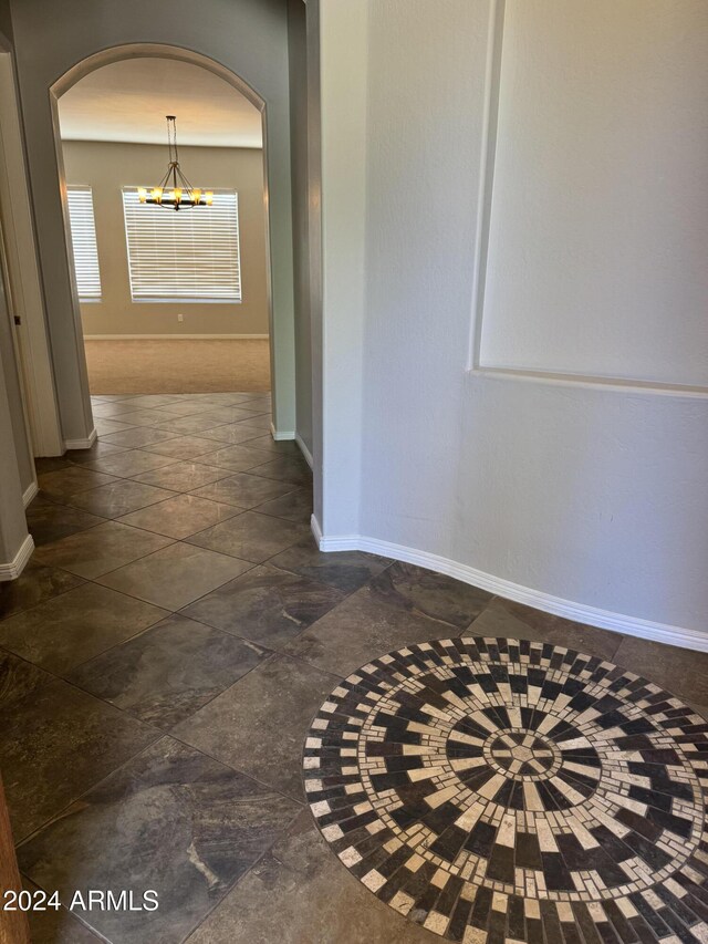 hallway featuring an inviting chandelier