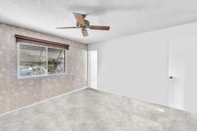 carpeted spare room with ceiling fan and a textured ceiling