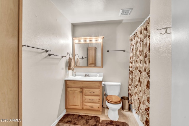 bathroom featuring vanity, a shower with shower curtain, visible vents, tile patterned flooring, and toilet