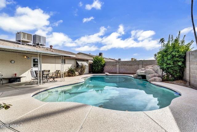 view of pool featuring a fenced in pool, a patio, central AC unit, and a fenced backyard