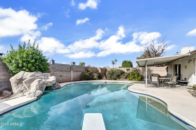 view of pool with a patio area, a diving board, a fenced backyard, and a fenced in pool