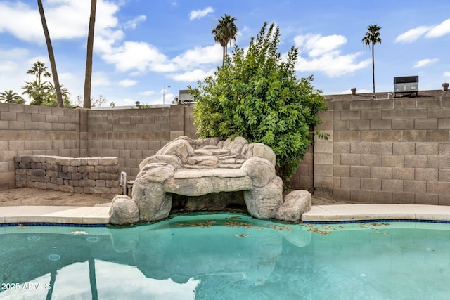 view of swimming pool featuring a fenced in pool and fence