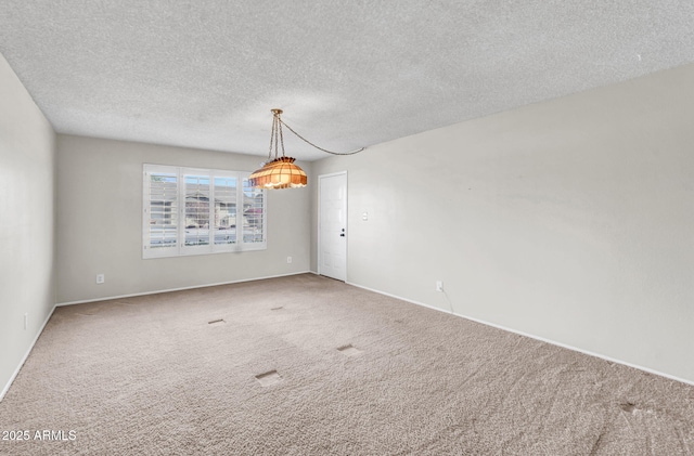 empty room featuring a textured ceiling and carpet floors